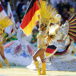 DANCERS PERFORM DURING IN FRONT OF A GERMAN FLAG